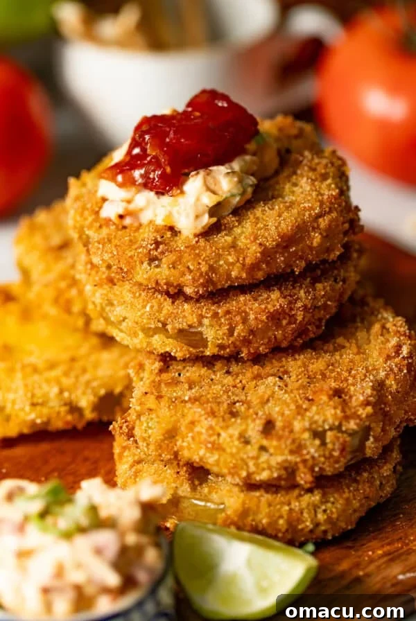 Crispy Tostones Recipe: Authentic Fried Plantains 12 fried green tomatoes stacked on top of one another with pimento cheese on top.