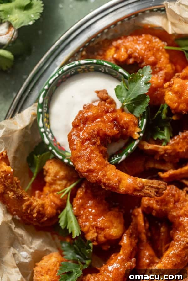Crispy Tostones Recipe: Authentic Fried Plantains 13 buffalo shrimp in a basket with a small bowl of blue cheese.