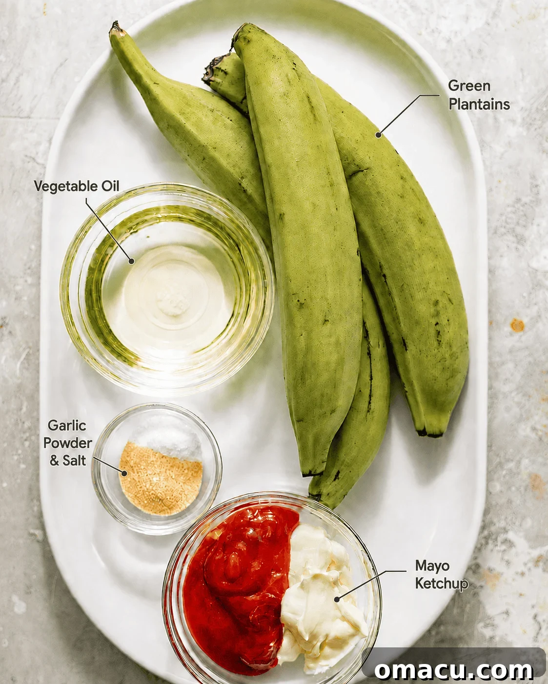 Crispy Tostones Recipe: Authentic Fried Plantains 3 ingredients to make tostones on a plate - green plantains, vegetable oil, garlic powder, kosher salt, black pepper, mayo, and ketchup.
