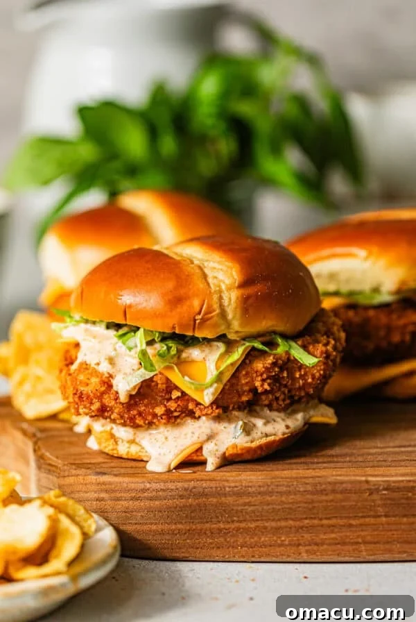 Crispy Tostones Recipe: Authentic Fried Plantains 10 fried fish sandwiches on a serving board with a bowl of potato chips on the side.