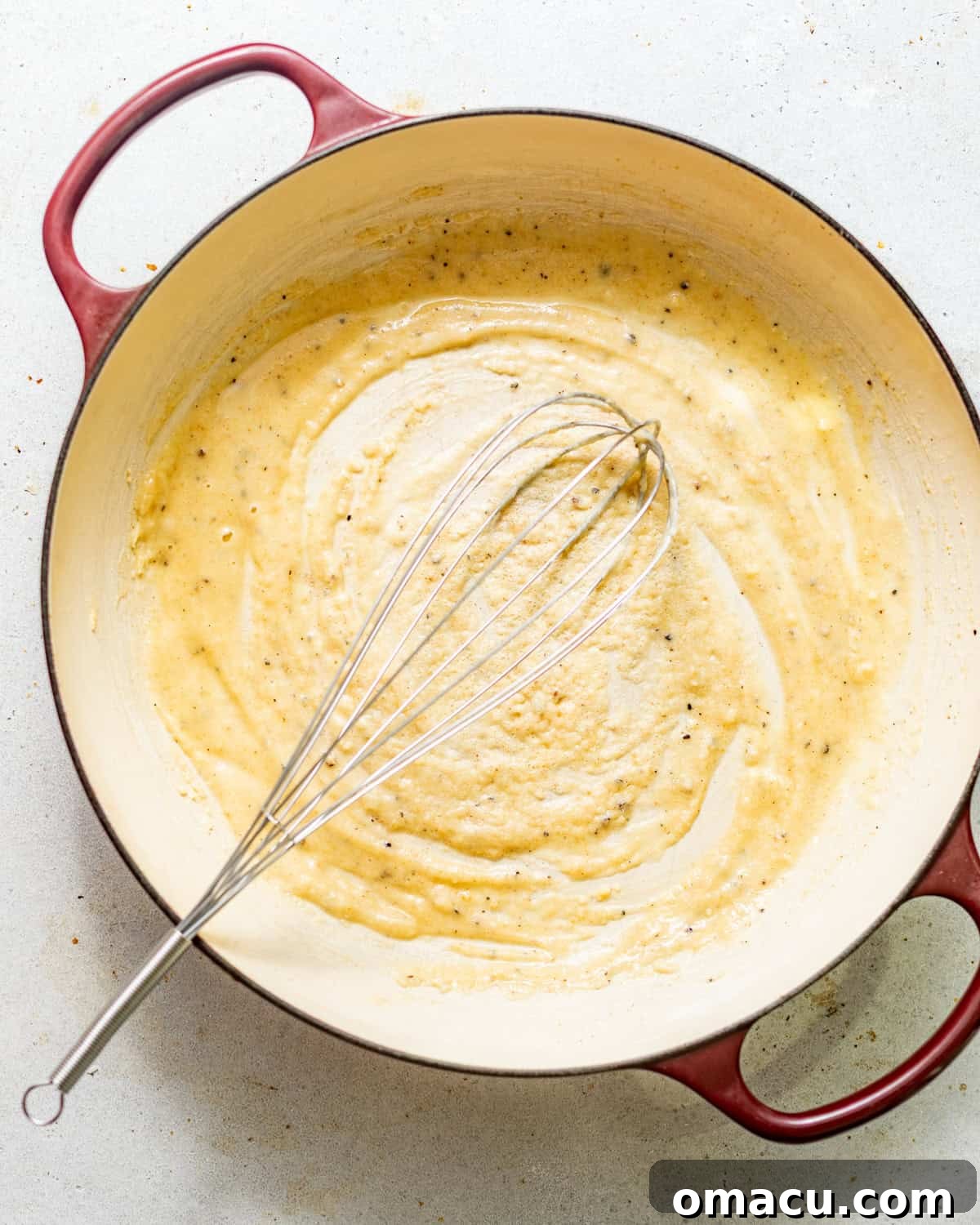 melted butter, seasonings, and flour mixed together in a pot to form the roux for the cheese sauce.