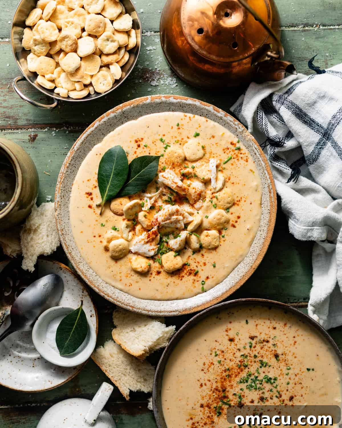 Classic She-Crab Soup: Southern Creamy Crab Recipe 1 she crab soup in a bowl in a bowl with a spoon, topped with oyster crackers and jumbo lump crab meat.