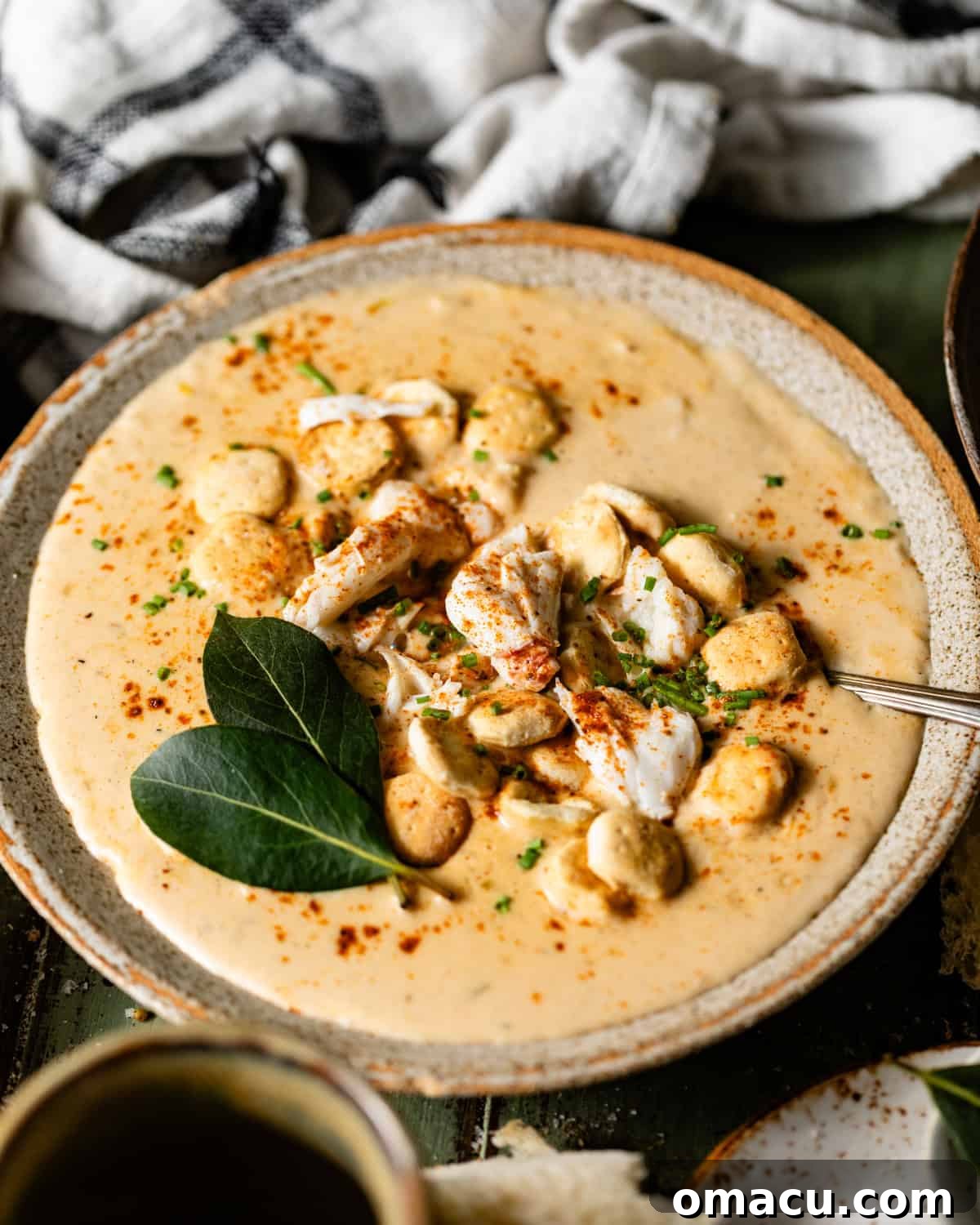 Classic She-Crab Soup: Southern Creamy Crab Recipe 7 she crab soup in a bowl with a spoon garnished with crabmeat.