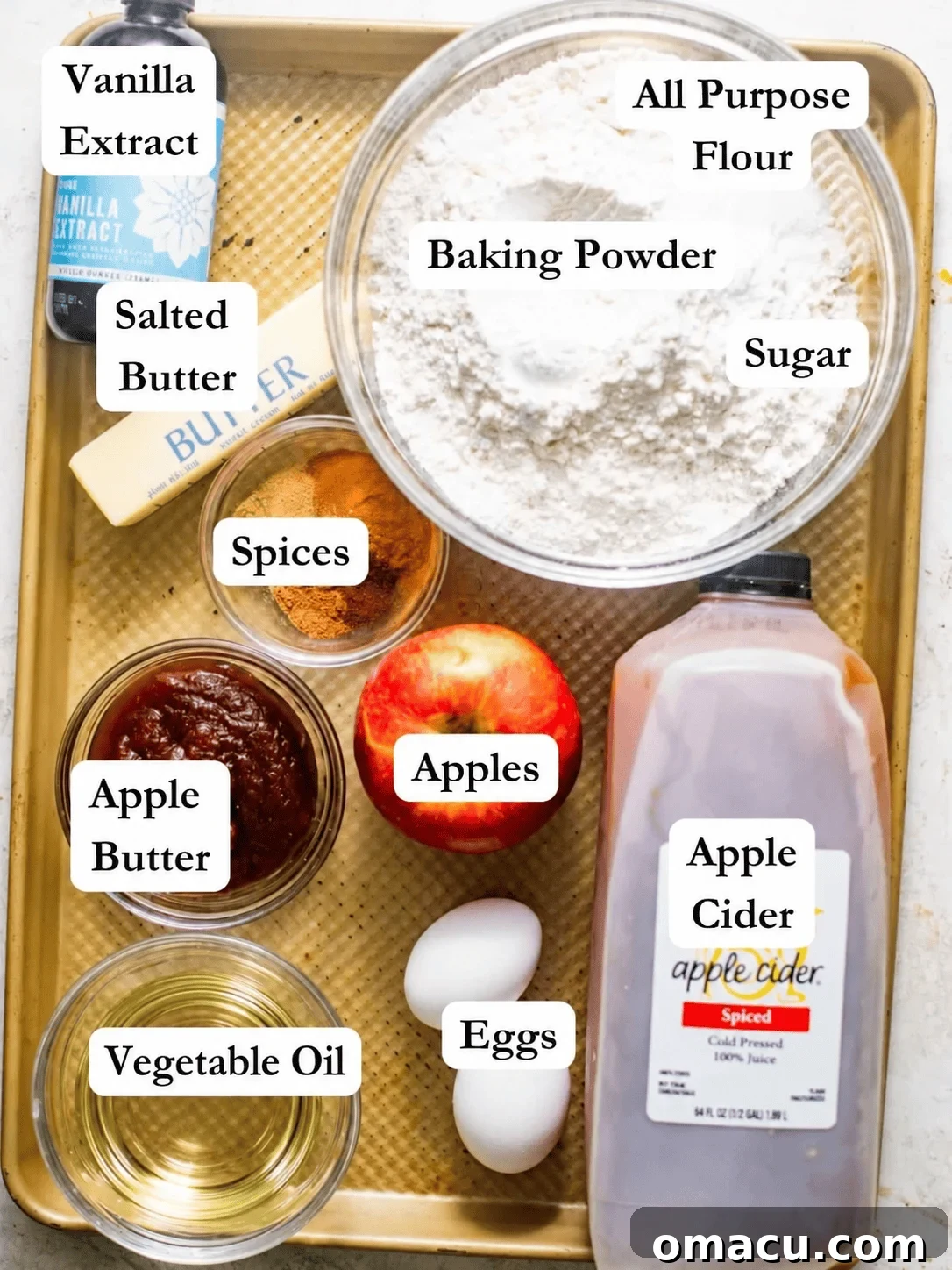Warm Apple Cider Donut Loaf with Cinnamon Glaze 3 apple cider donut bread ingredients - flour, sugar, apple cider, apple butter, spices, vegetable oil, eggs, vanilla extract, and butter.