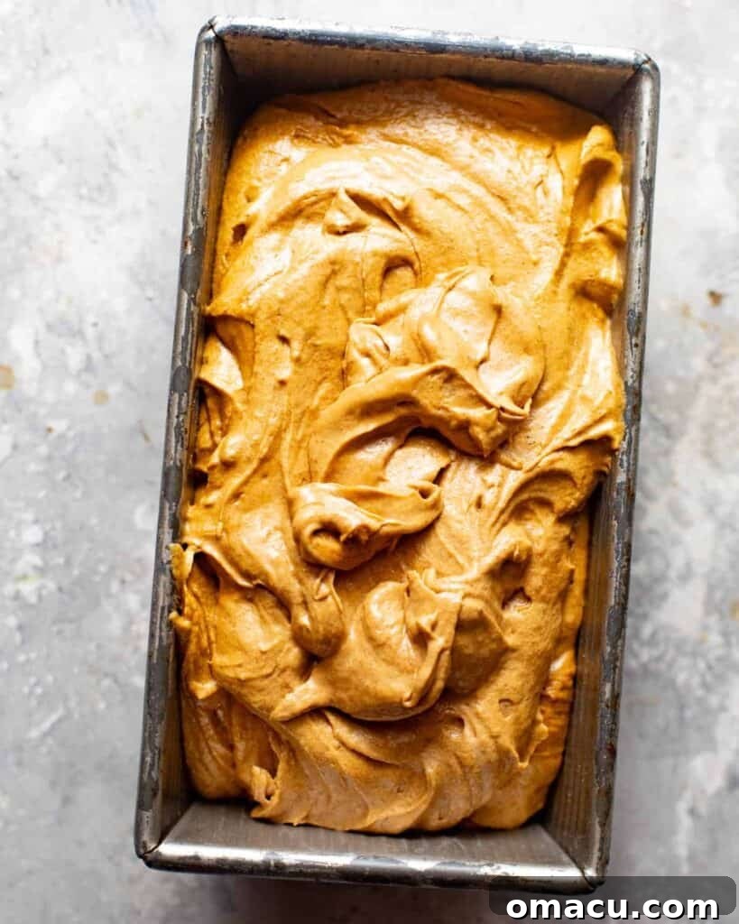 Warm Apple Cider Donut Loaf with Cinnamon Glaze 5 cake batter added to the loaf pan.